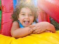 preschool-girl-smiling-portrait-in-bouncy-house-2024-11-26-18-59-12-utc